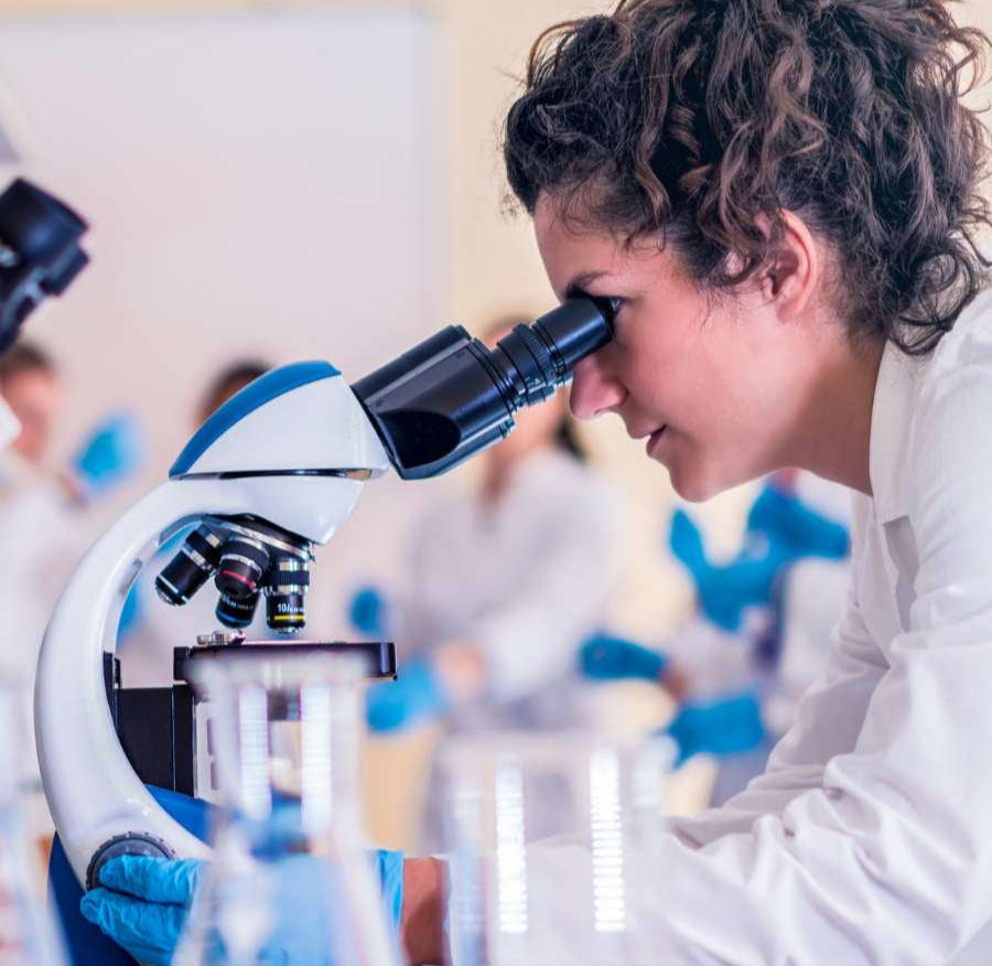 Person using a microscope in a laboratory setting